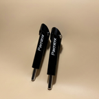 Black Pintryx drop set pins standing straight up on beige background.