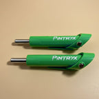Green Pintryx drop set pins laying flat on beige background.