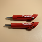 Red Pintryx drop set pins laying flat on beige background.