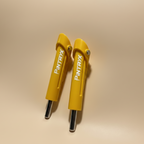 Yellow Pintryx drop set pins standing straight up on beige background.